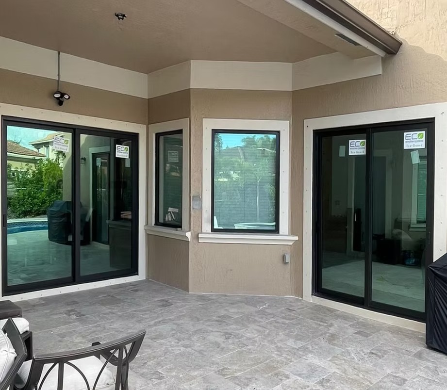 Black-framed patio impact windows and sliding doors from the M&T project gallery